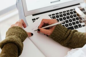 Patient Taking Notes During Online Appointment for Care Plan