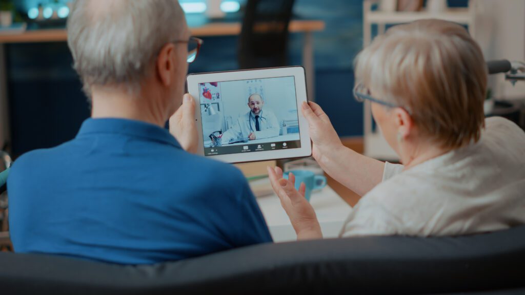 Couple engaged in a telehealth appointment using a mobile device