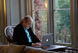 Online medical appointment: Man having a virtual consultation with a psychcologist on his laptop