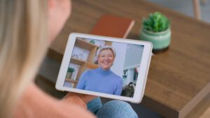 A virtual support session, showing individuals engaged in a group discussion or receiving counseling via video call. This image highlights the empowerment and community aspect of virtual interventions for anxiety disorders.