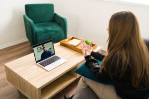 A person having a virtual psychological evaluation with a therapist via video call, illustrating the convenience of virtual assessments for anxiety disorders.