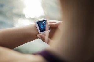 A patient wearing a smartwatch, checking health stats remotely