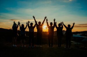 A diverse group of individuals engaged in a supportive conversation or group therapy session, demonstrating community and support in mental health care.