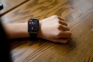 A person wearing a smartwatch, monitoring their health vitals, illustrating the concept of remote monitoring in healthcare.