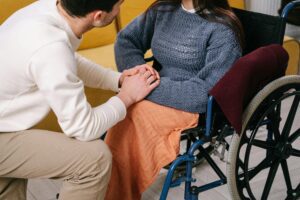 A caregiver providing emotional support to a woman, engaging in a calm and reassuring conversation before her surgery.